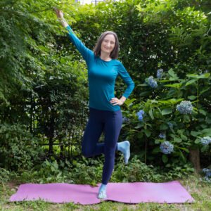 The instructor demonstrating a a hamstring and glute-strengthening exercise from the Aviva Method for Men to improve circulation, hormonal balance, and reproductive health.