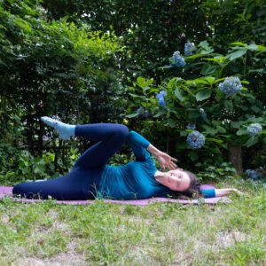 Woman practicing a gentle postpartum exercise from the MomMeTime routine to strengthen the pelvic floor and support full-body recovery after childbirth.